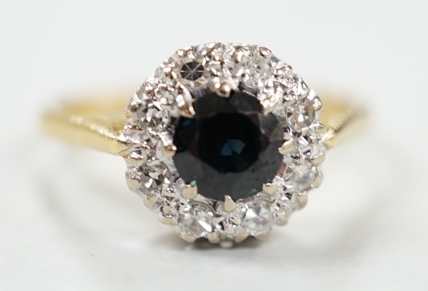 A 1960's 18ct gold, sapphire and diamond set circular cluster ring, size N, gross weight 3.7 grams.